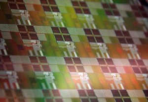 Silicon wafer with photonic-electronic microchips designed by CU research team